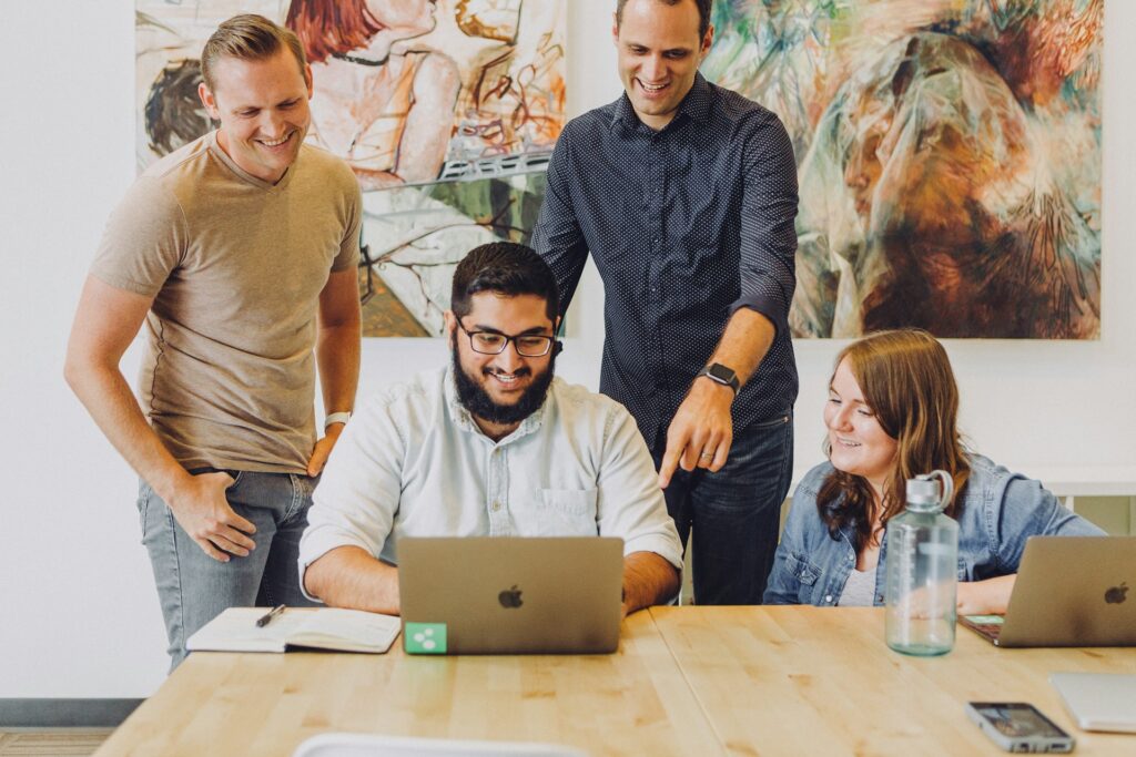 Team reviewing AI outputs together on a laptop